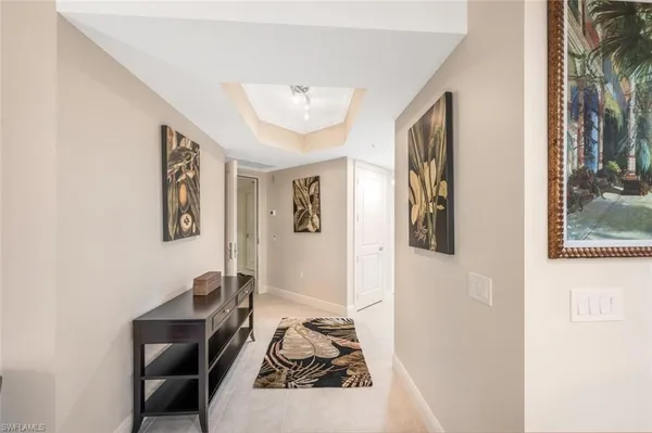 a living room with furniture and a painting on the wall