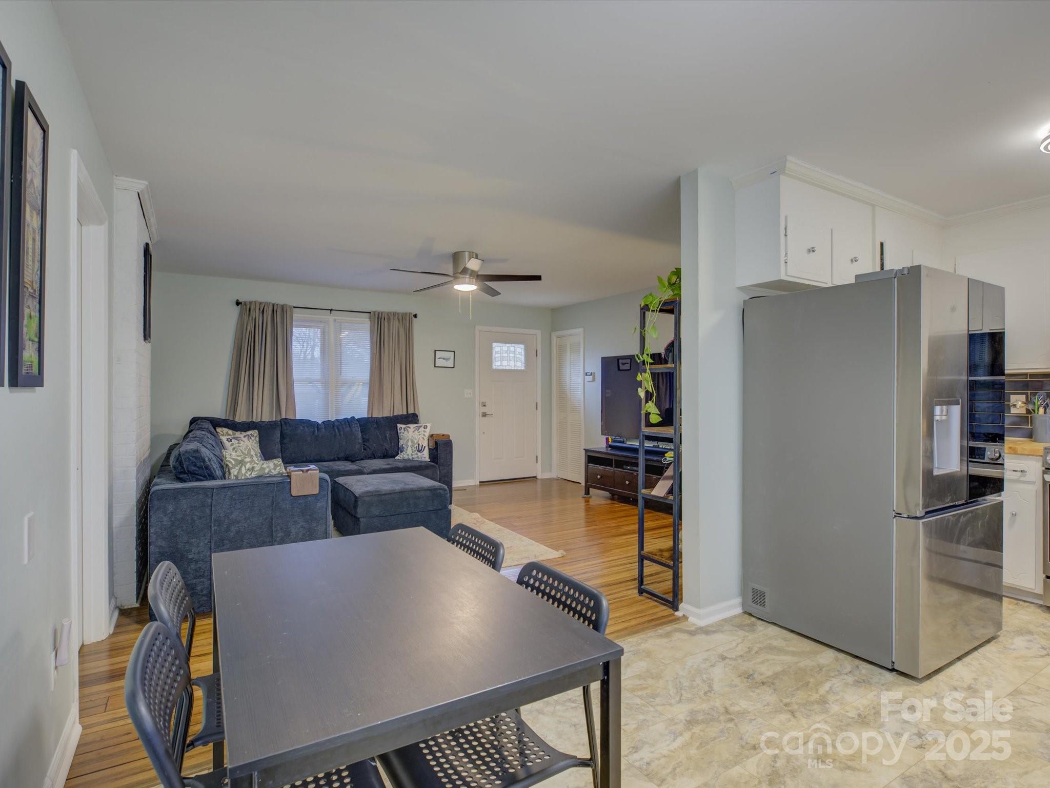 228 Ridge Drive Harrisburg, NC 28075 - Photo 11 of 27 a living room with furniture a refrigerator and a dining table
