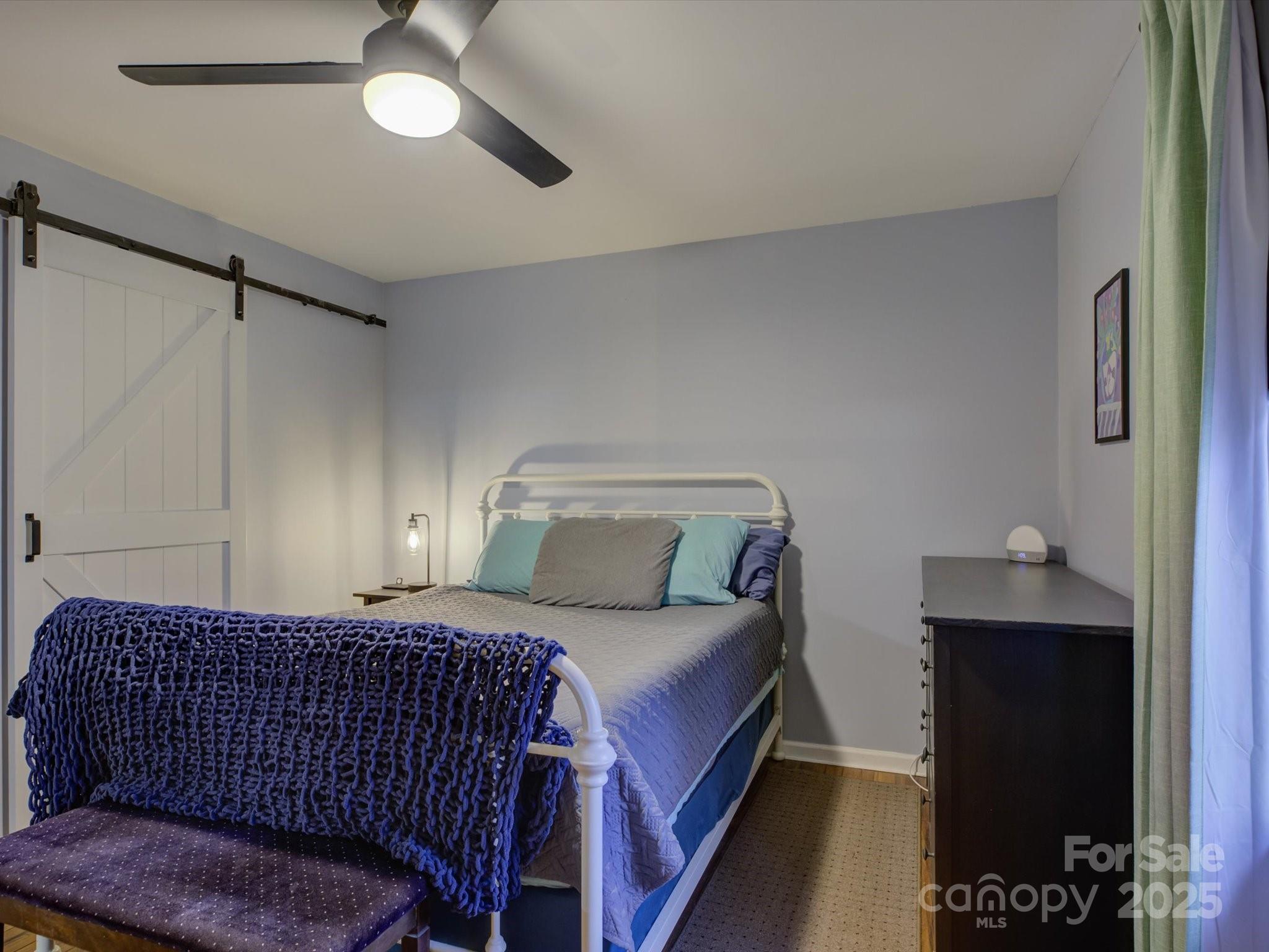 228 Ridge Drive Harrisburg, NC 28075 - Photo 14 of 27 a bedroom with a bed and wooden floor