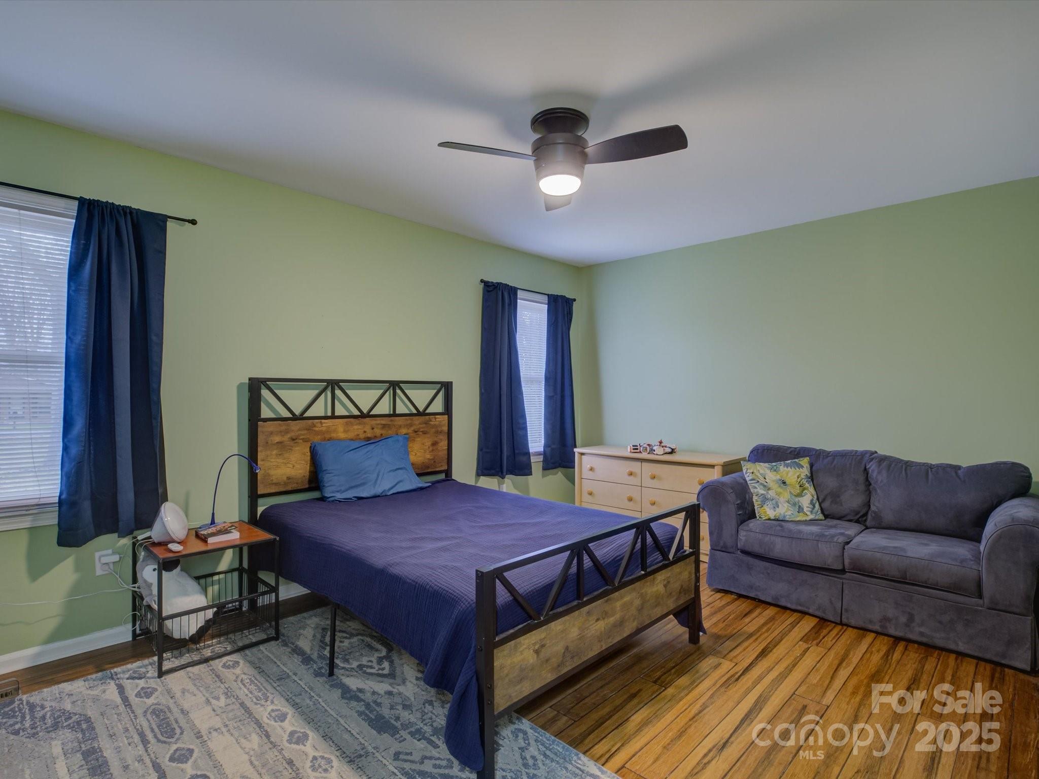 228 Ridge Drive Harrisburg, NC 28075 - Photo 23 of 27 a bedroom with a bed and a couch