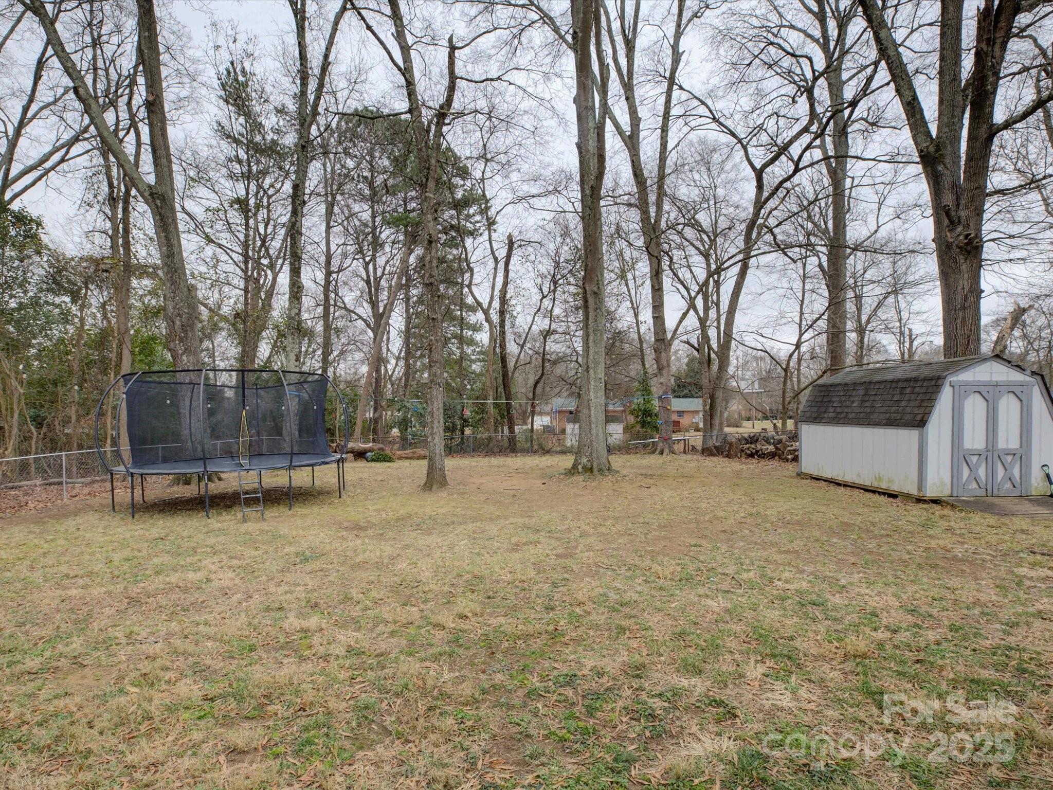 228 Ridge Drive Harrisburg, NC 28075 - Photo 25 of 27 a view of a field with trees in front of it