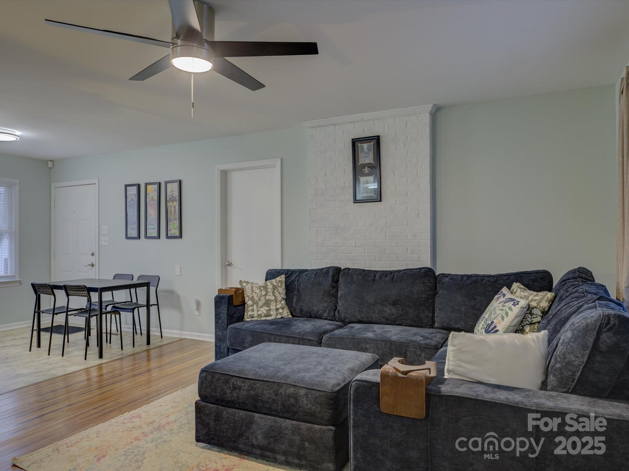 228 Ridge Drive Harrisburg, NC 28075 - Photo 5 of 27 a living room with furniture and a dining table with wooden floor