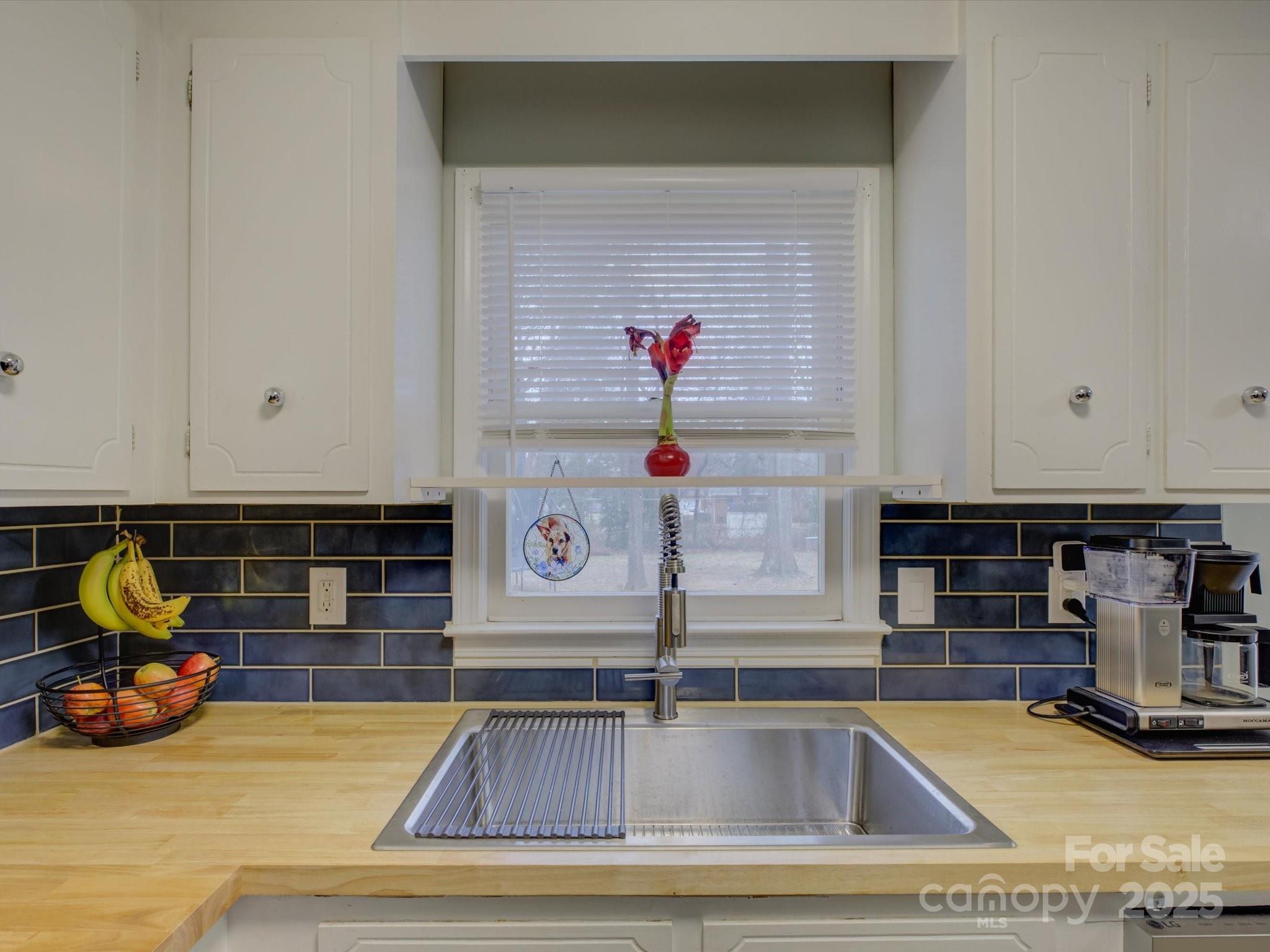 228 Ridge Drive Harrisburg, NC 28075 - Photo 10 of 27 a kitchen with kitchen island a stove and a sink