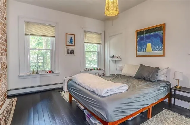 a bed sitting in a bedroom next to a window