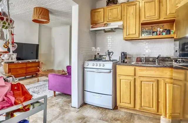 a kitchen with stainless steel appliances granite countertop a sink dishwasher stove and cabinets
