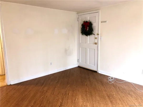 an empty room with wooden floor and closet
