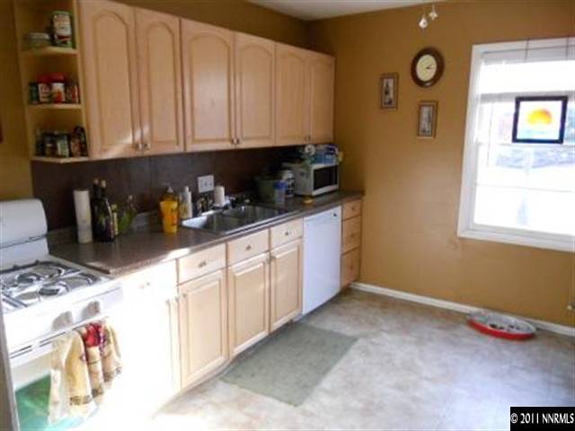 650 Hood Avenue Reno, NV 89512 - Photo 7 of 12 a kitchen with stainless steel appliances granite countertop a sink and cabinets