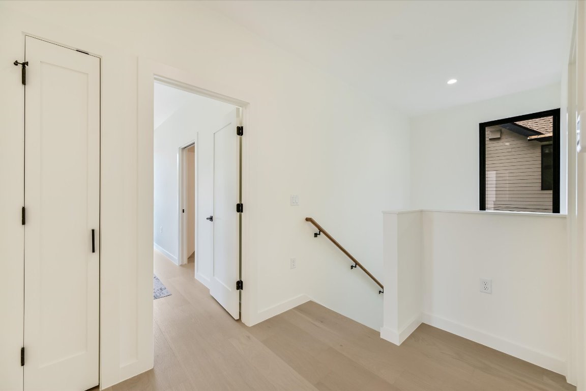 2705 Francisco Street, Unit A Austin, TX 78702 - Photo 12 of 21 Hallway with an upstairs landing, light wood-style floors, and recessed lighting
