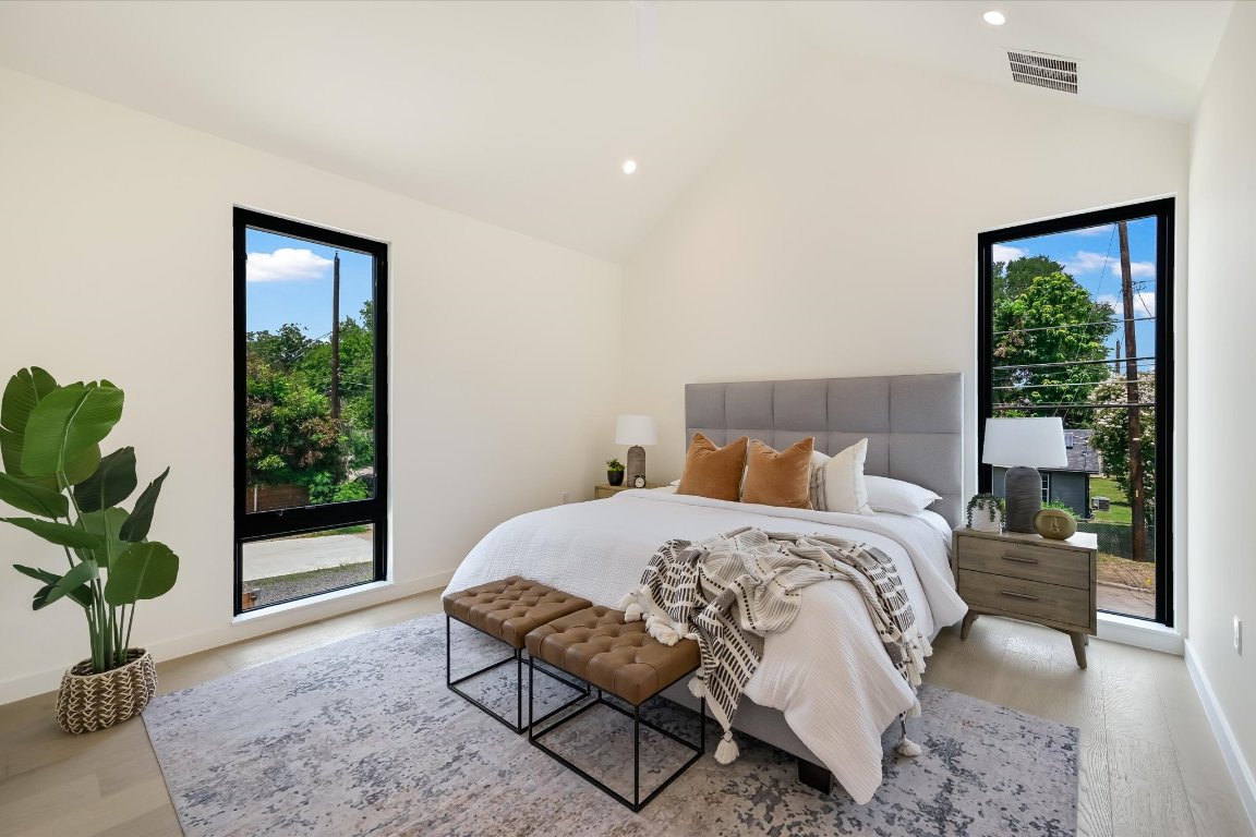 2705 Francisco Street, Unit A Austin, TX 78702 - Photo 13 of 21 Bedroom featuring light wood finished floors, multiple windows, recessed lighting, high vaulted ceiling, and access to outside