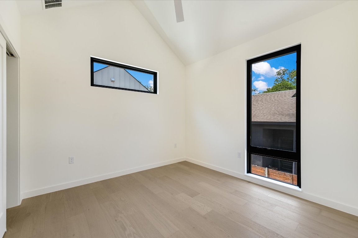 2705 Francisco Street, Unit A Austin, TX 78702 - Photo 15 of 21 Empty room featuring light wood-style floors and high vaulted ceiling