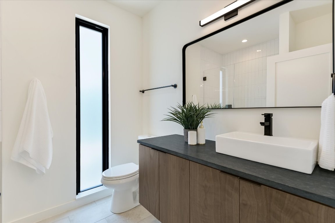 2705 Francisco Street, Unit A Austin, TX 78702 - Photo 16 of 21 Full bath with vanity, a shower stall, tile patterned floors, and recessed lighting