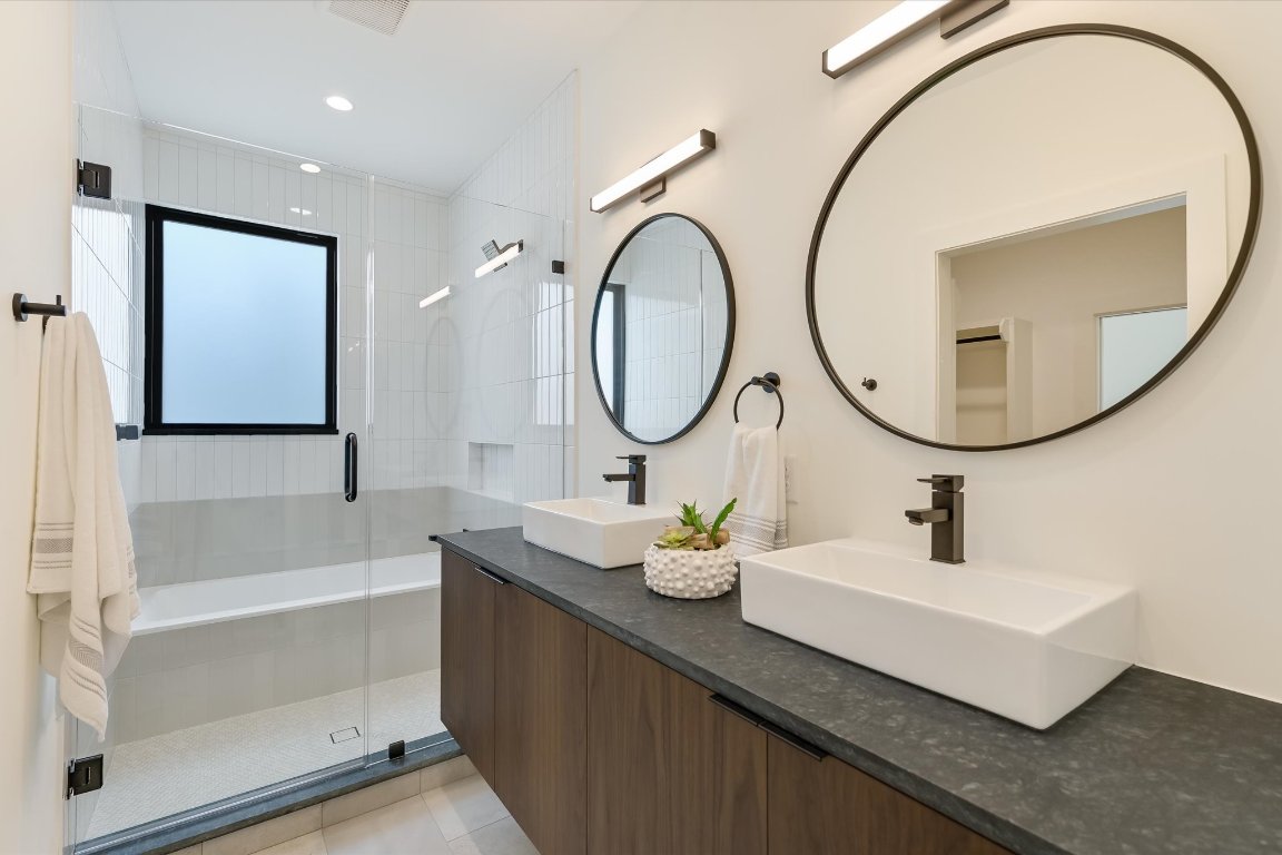 2705 Francisco Street, Unit A Austin, TX 78702 - Photo 4 of 21 Bathroom featuring a stall shower, double vanity, tile patterned floors, and recessed lighting