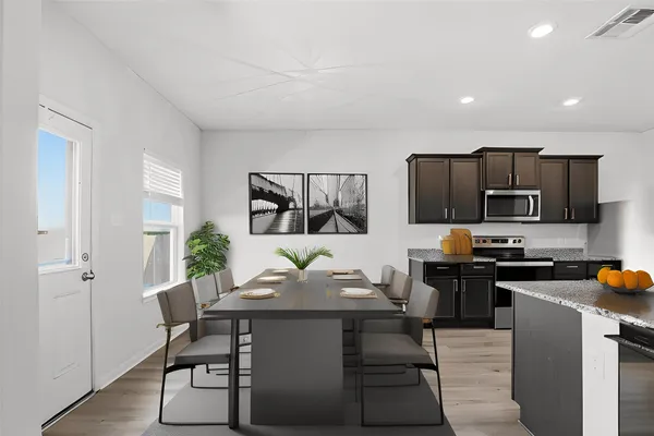 a kitchen with stainless steel appliances granite countertop a refrigerator a stove top oven a sink and dishwasher