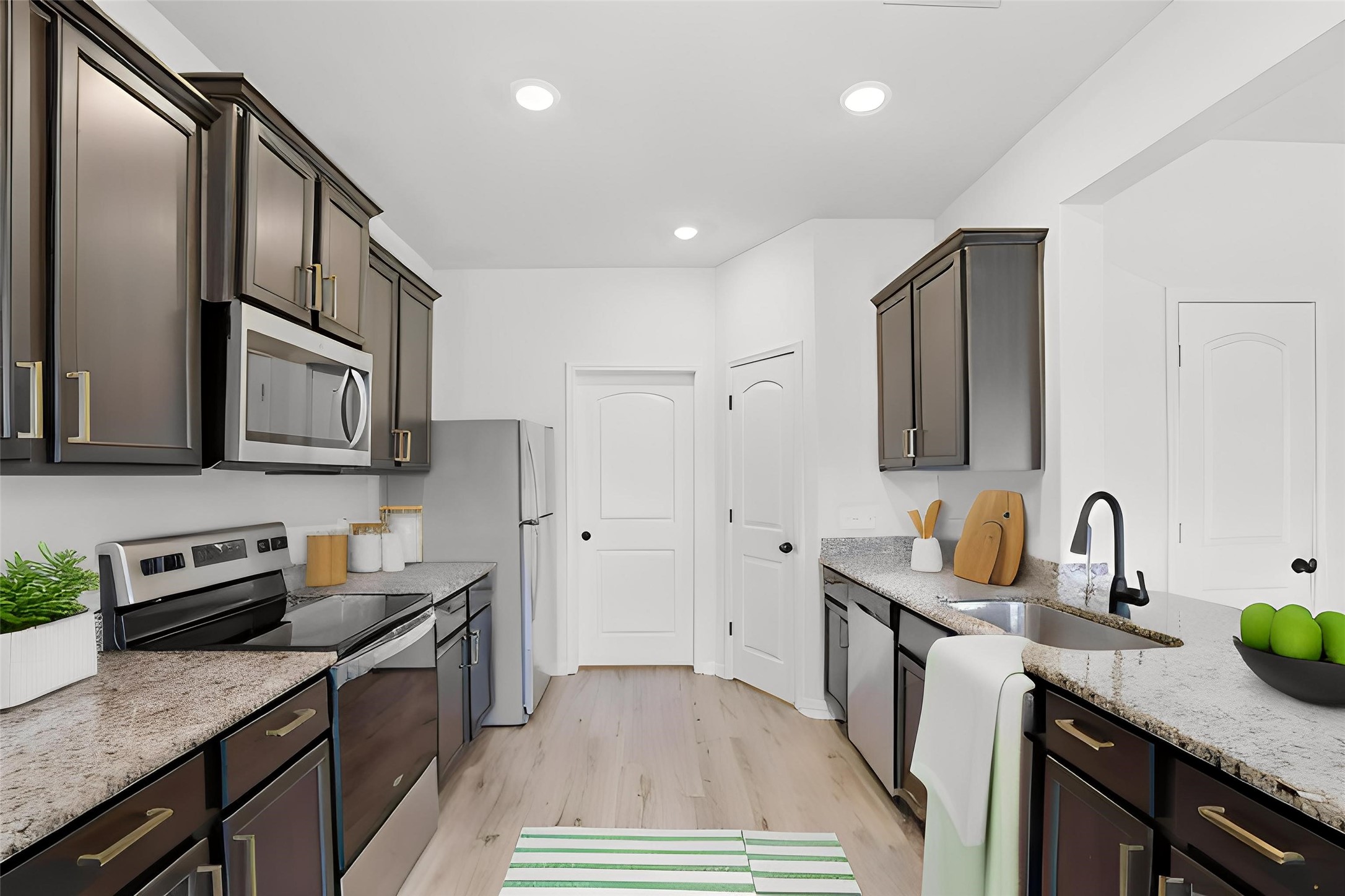2044 Mule Ridge Drive Katy, TX 77493 - Photo 15 of 38 a kitchen with stainless steel appliances granite countertop a sink stove and refrigerator