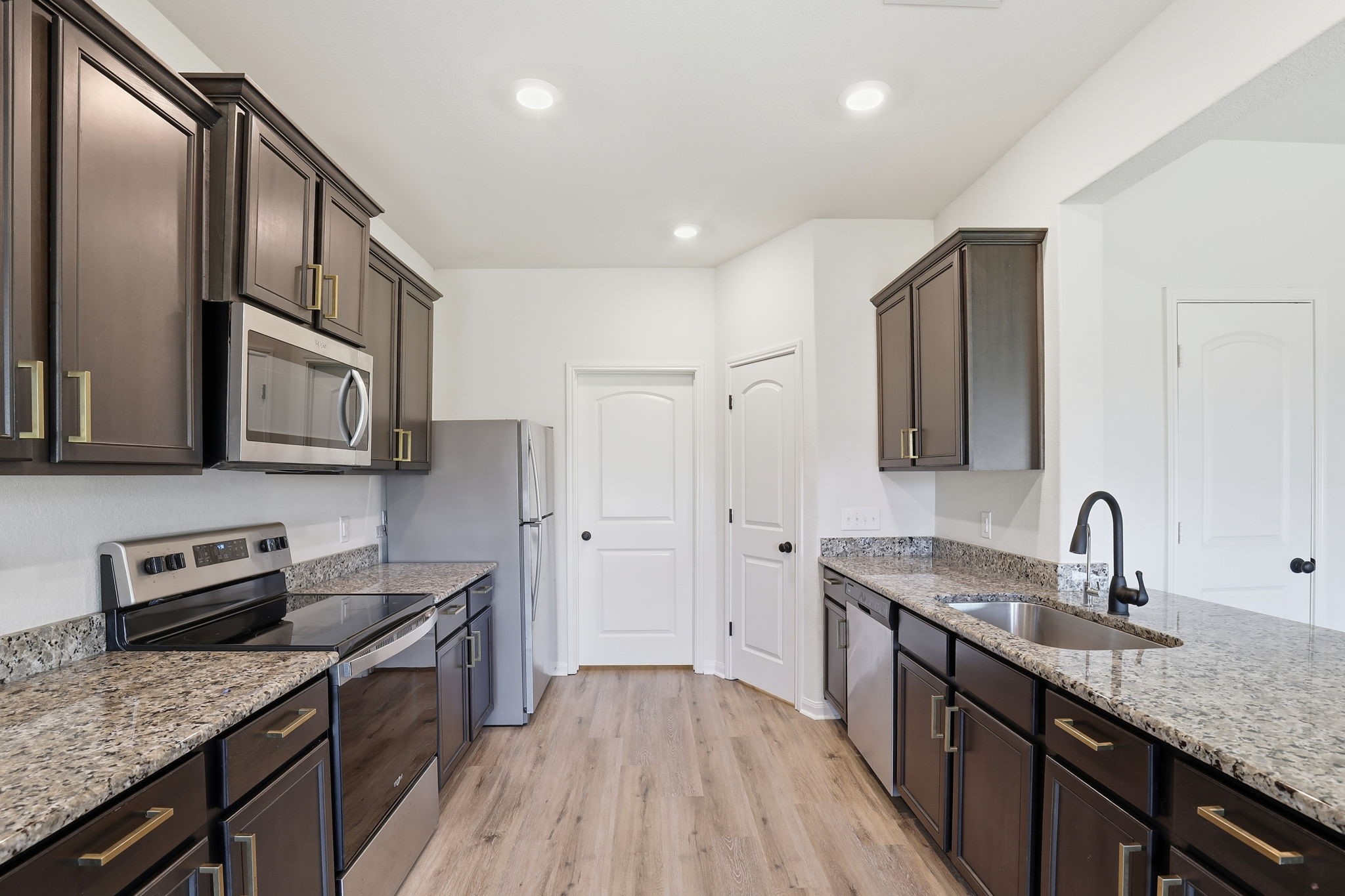 2044 Mule Ridge Drive Katy, TX 77493 - Photo 16 of 38 a kitchen with stainless steel appliances granite countertop a sink stove and refrigerator