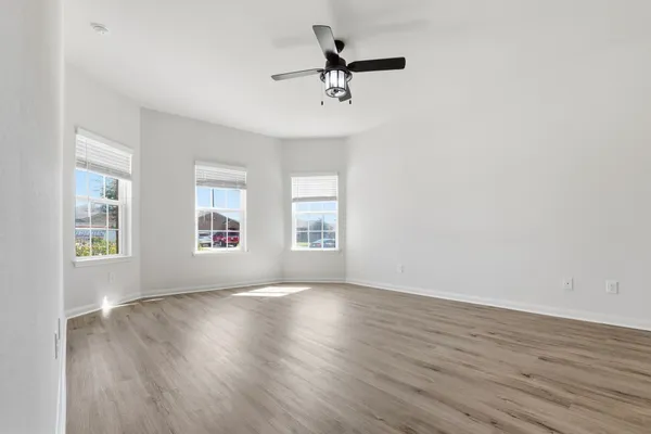 a view of an empty room with wooden floor