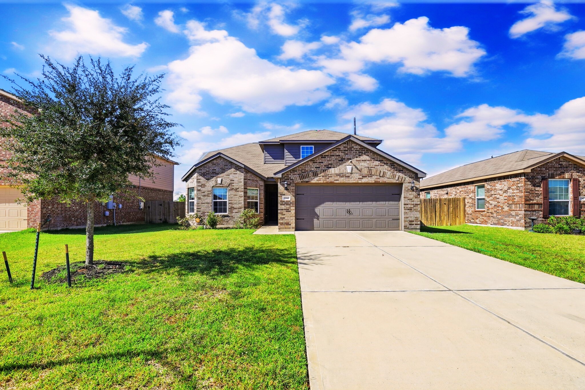 2044 Mule Ridge Drive Katy, TX 77493 - Photo 2 of 38 a view of a house with a big yard plants and large trees