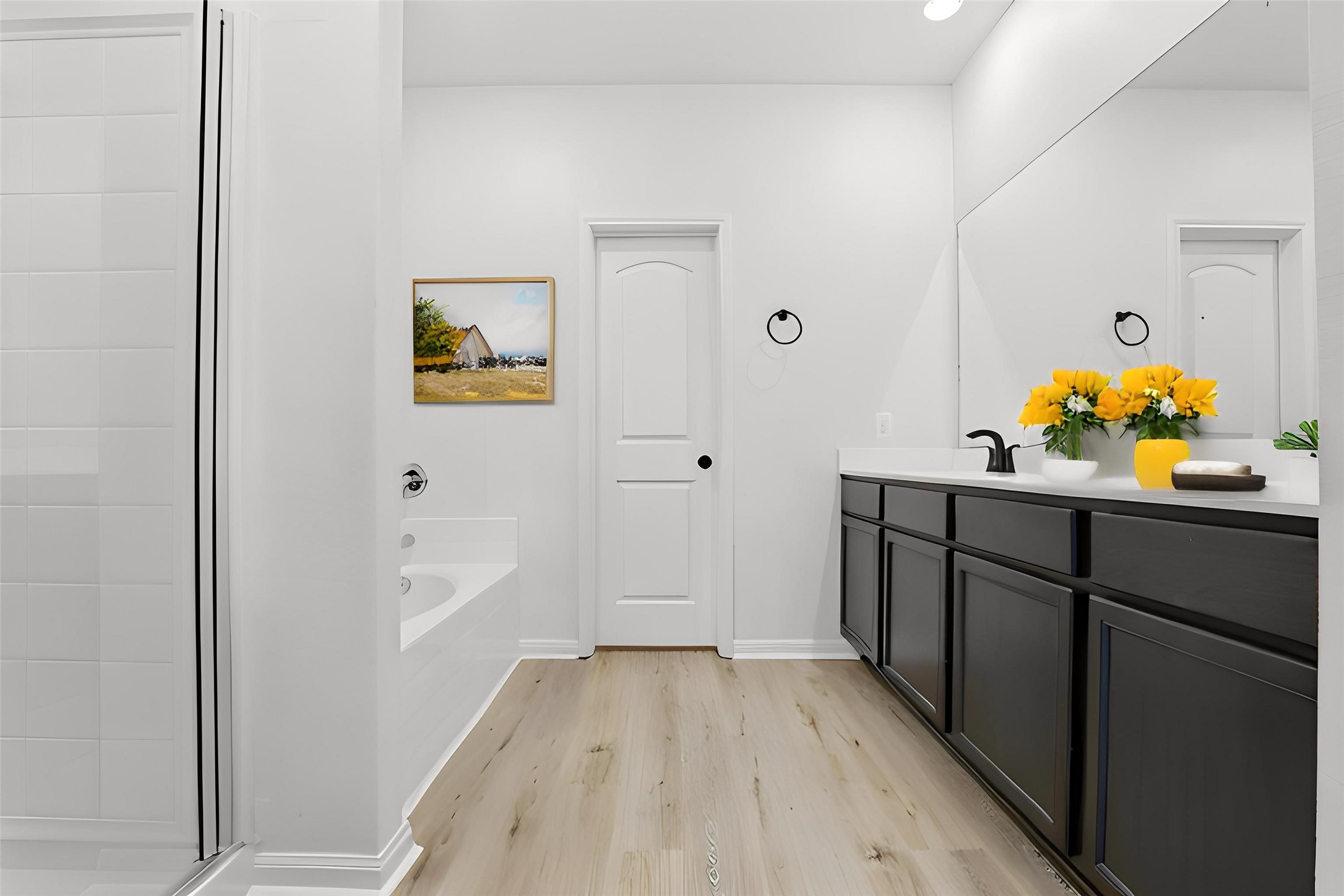 2044 Mule Ridge Drive Katy, TX 77493 - Photo 21 of 38 a hallway with painting on the wall and a wooden floor