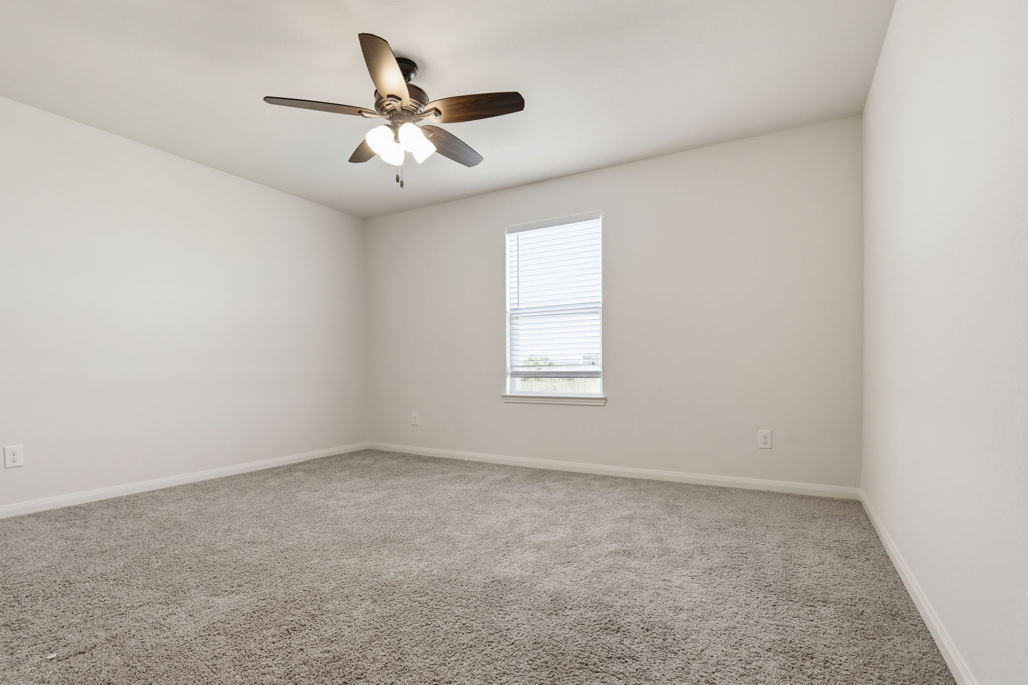2044 Mule Ridge Drive Katy, TX 77493 - Photo 32 of 38 an empty room with ceiling fan and window