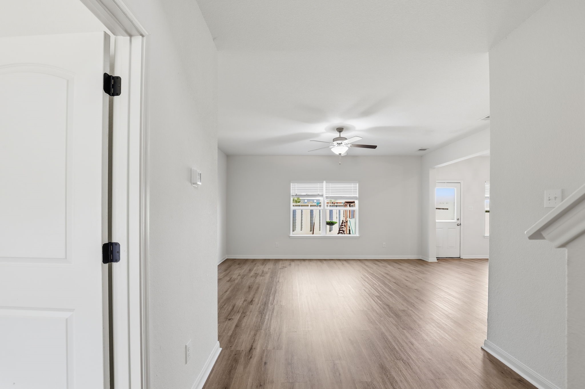 2044 Mule Ridge Drive Katy, TX 77493 - Photo 5 of 38 wooden floor in an empty room with a window