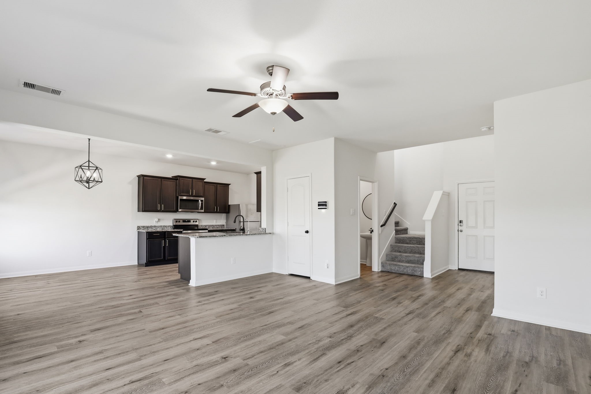 2044 Mule Ridge Drive Katy, TX 77493 - Photo 8 of 38 a view of kitchen with sink microwave refrigerator and stove