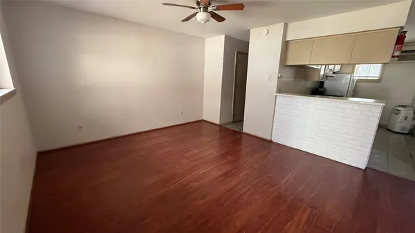 a view of a kitchen with a sink and a refrigerator