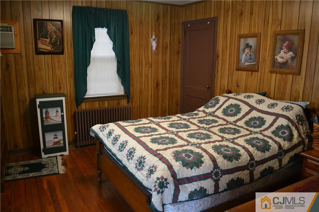 1526 Englishtown Road Old Bridge, NJ 08857 - Photo 3 of 6 a bedroom with a bed and wooden floor