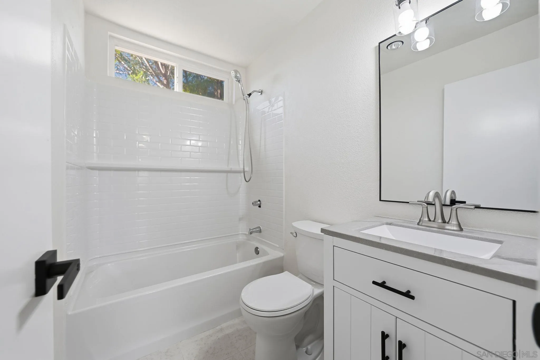 12621 Lindo Lane Lakeside, CA 92040 - Photo 12 of 28 a bathroom with a granite countertop sink a toilet and a bathtub
