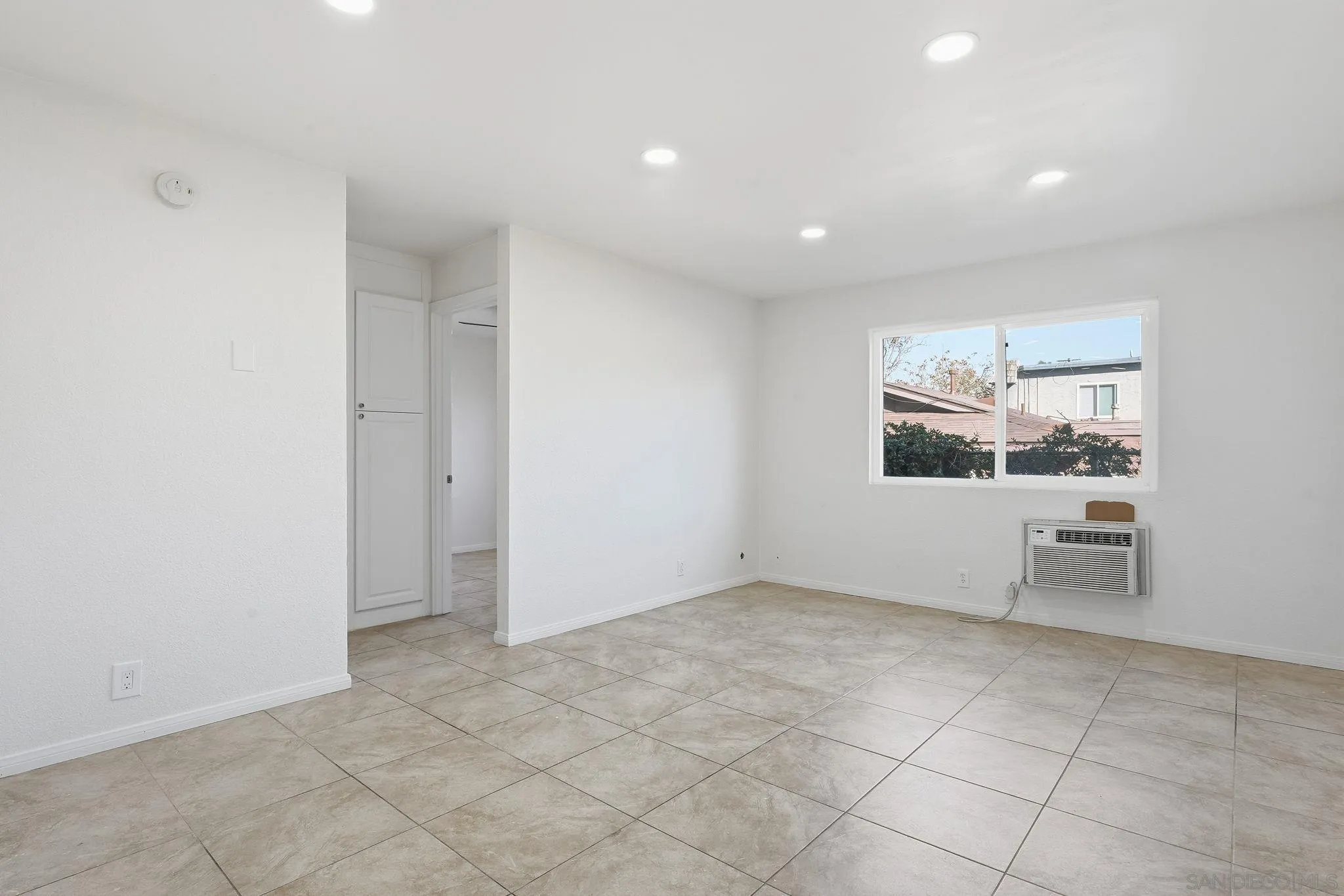 12621 Lindo Lane Lakeside, CA 92040 - Photo 18 of 28 an empty room with windows and fireplace