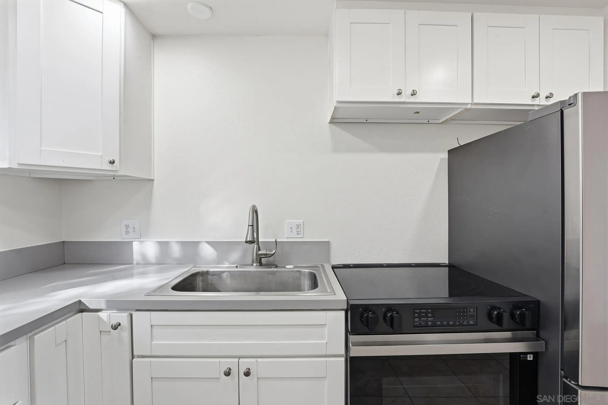 12621 Lindo Lane Lakeside, CA 92040 - Photo 20 of 28 a kitchen with a sink stove and cabinets