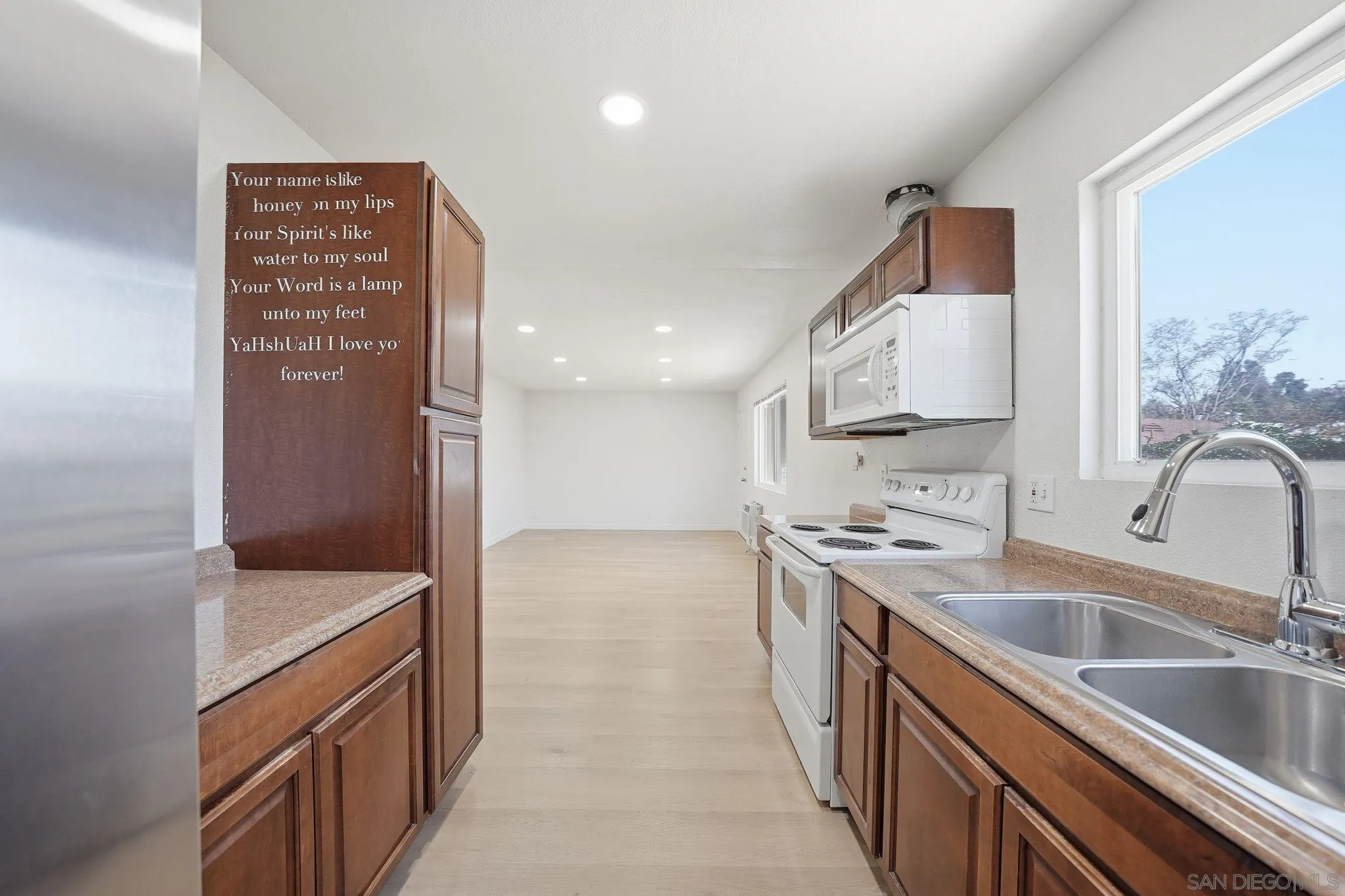 12621 Lindo Lane Lakeside, CA 92040 - Photo 9 of 28 a kitchen with a sink stove top oven and refrigerator