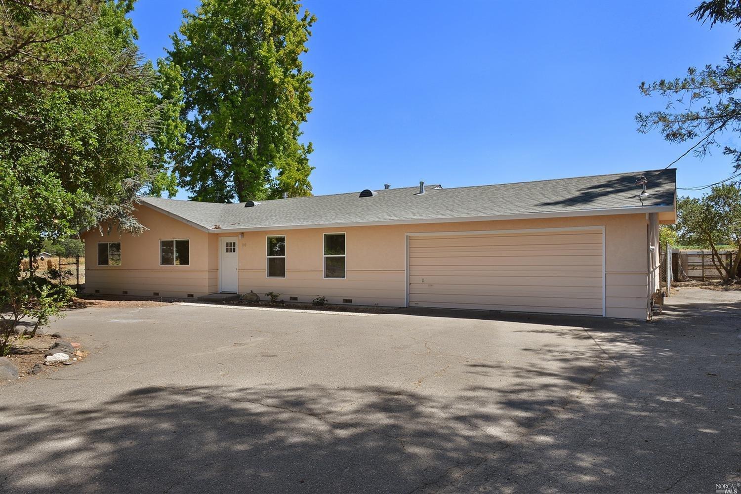 2700 Guerneville Road Santa Rosa, CA 95401 - Photo 1 of 1 a front view of a house with a yard