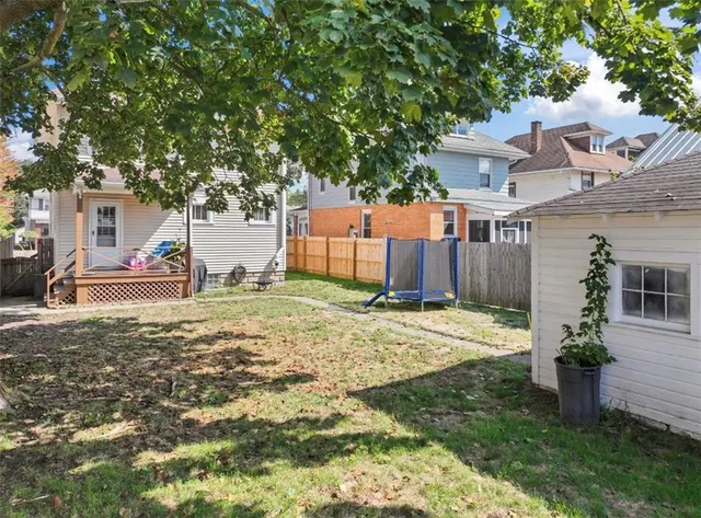 a backyard of a house with table and chairs