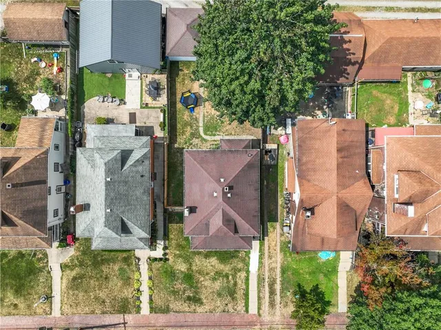 an aerial view of residential houses with outdoor space and street view