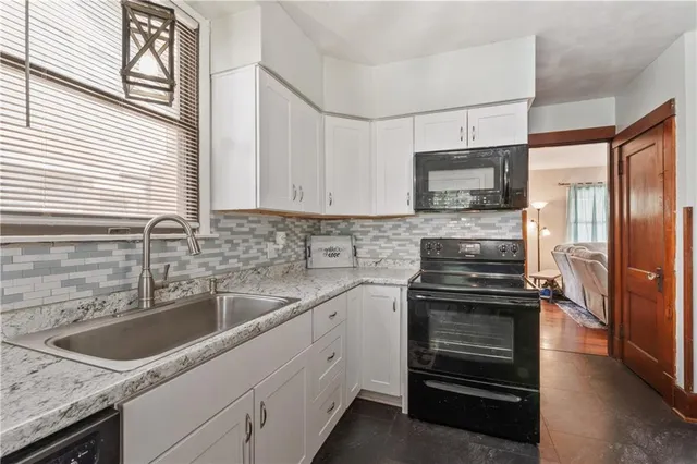 a kitchen with a sink stove and refrigerator