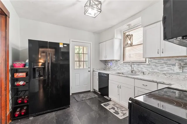 a kitchen with stainless steel appliances granite countertop a refrigerator and a sink