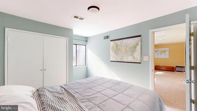 a bedroom with a bed and a view of bedroom