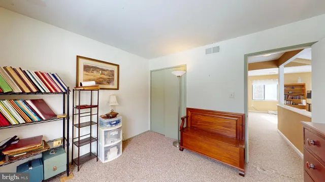 a room with bookshelf closet and furniture