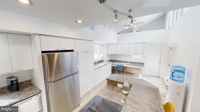 a kitchen with stainless steel appliances a refrigerator sink and stove