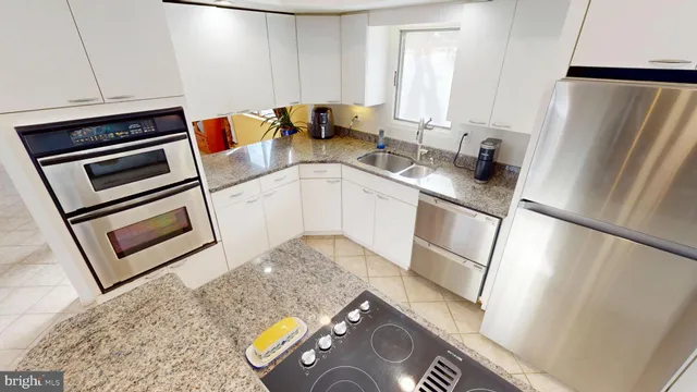 a kitchen with a sink appliances and cabinets