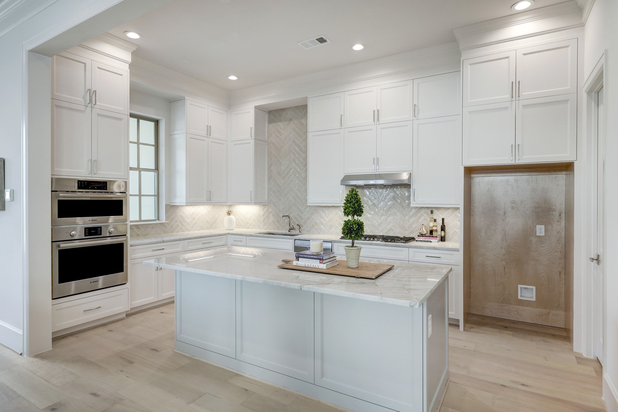 111 Wellington Row Road Houston, TX 77024 - Photo 3 of 19 a kitchen with kitchen island white cabinets and refrigerator