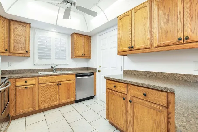 a kitchen with granite countertop white cabinets and stainless steel appliances