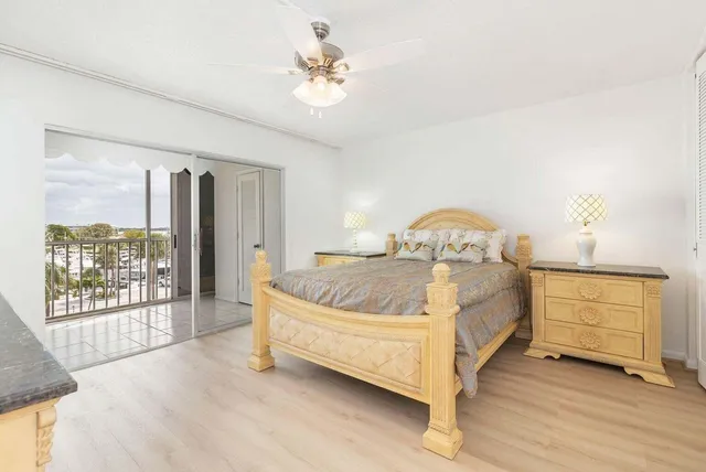 a bed sitting in a spacious bedroom next to a window