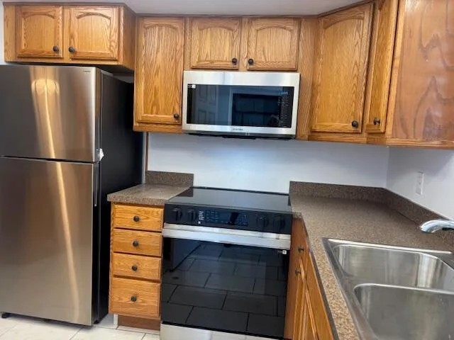 a kitchen with a refrigerator and a sink