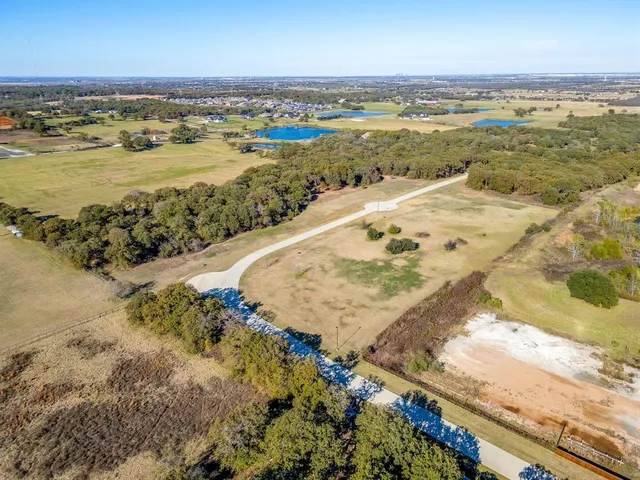 an aerial view of residential building and lake