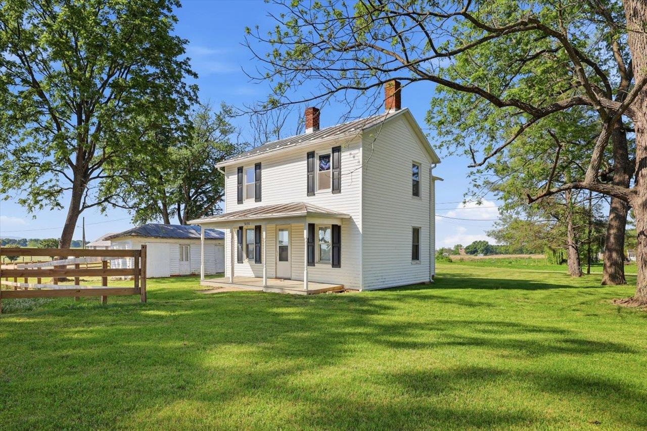 a front view of house with yard and green space