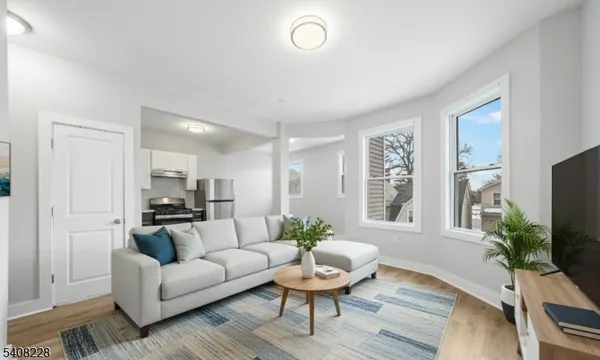 a living room with furniture potted plant and a window