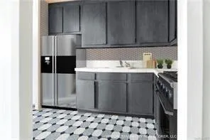 a kitchen with a sink a stove and refrigerator