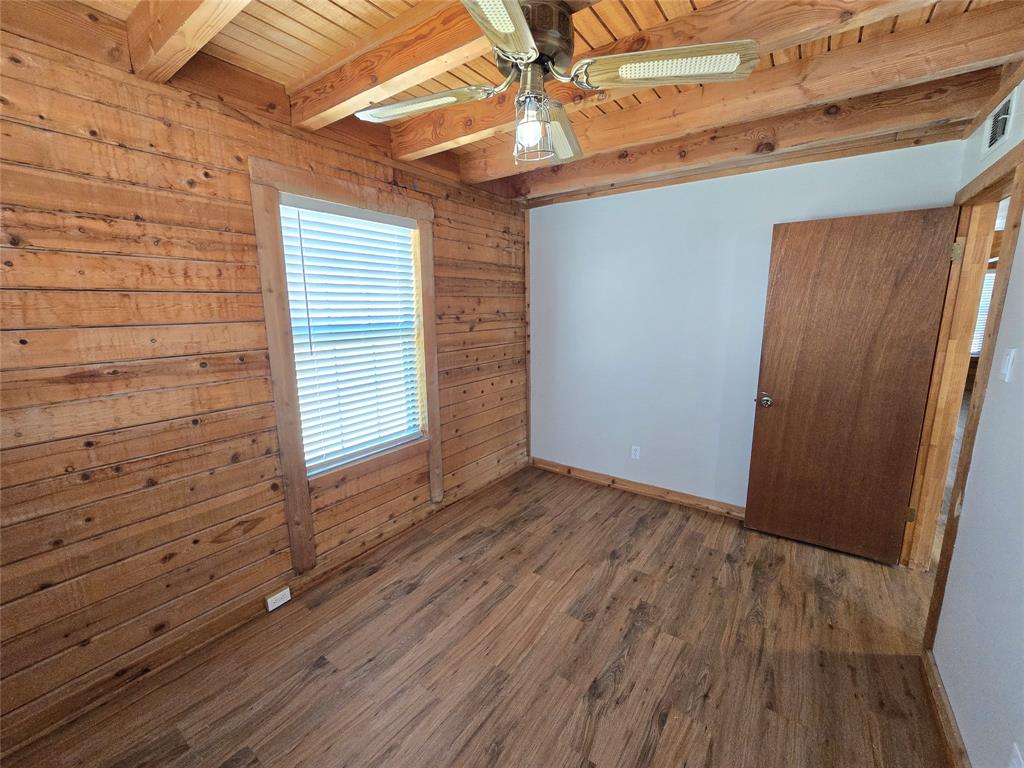 3505 Farmer Road Azle, TX 76020 - Photo 12 of 40 Rear bedroom downstairs has a ceiling fan--plus, new wood-look luxury vinyl plank flooring and window blinds--installed summer 2026!