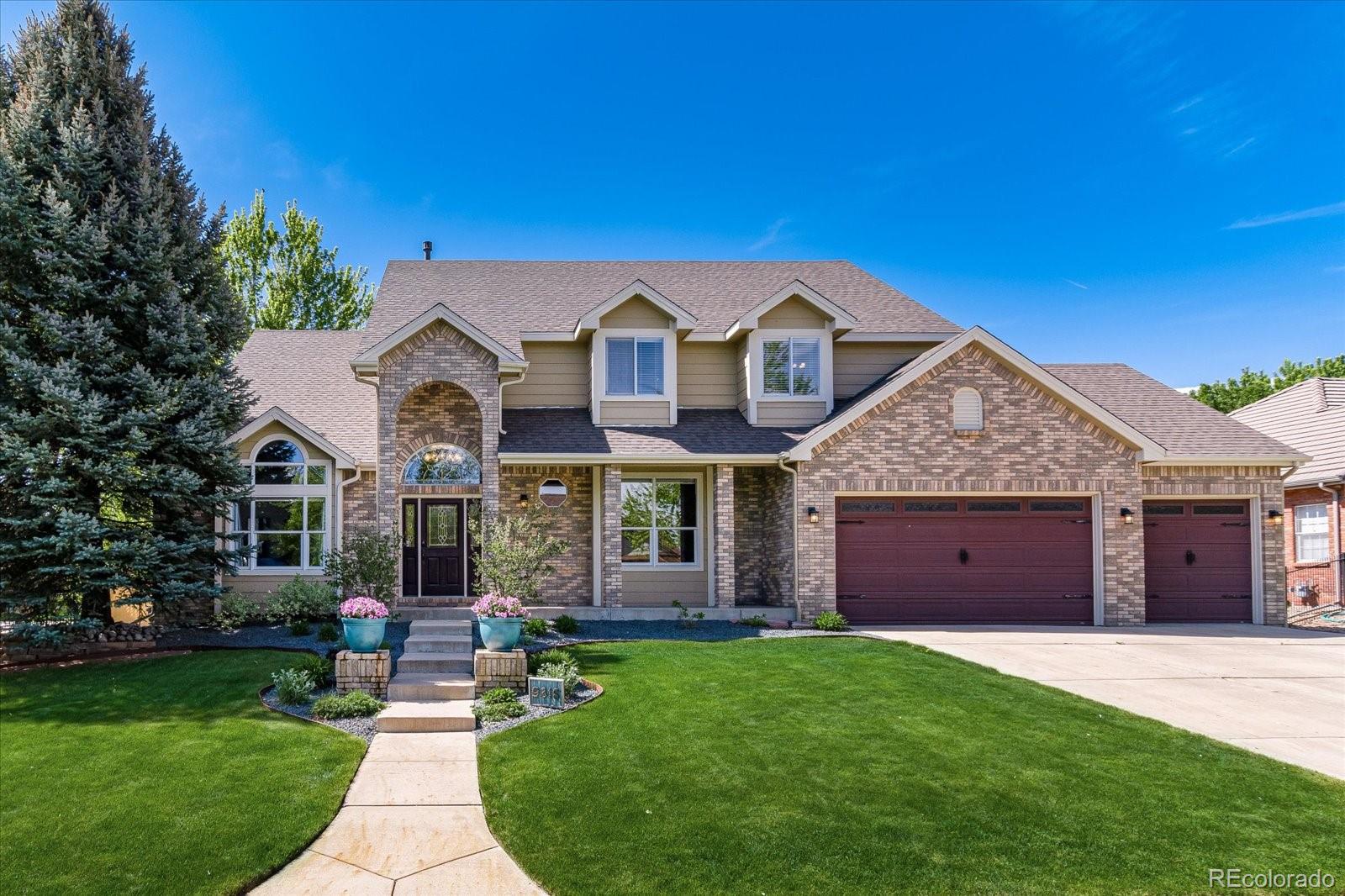 a front view of a house with a garden and yard